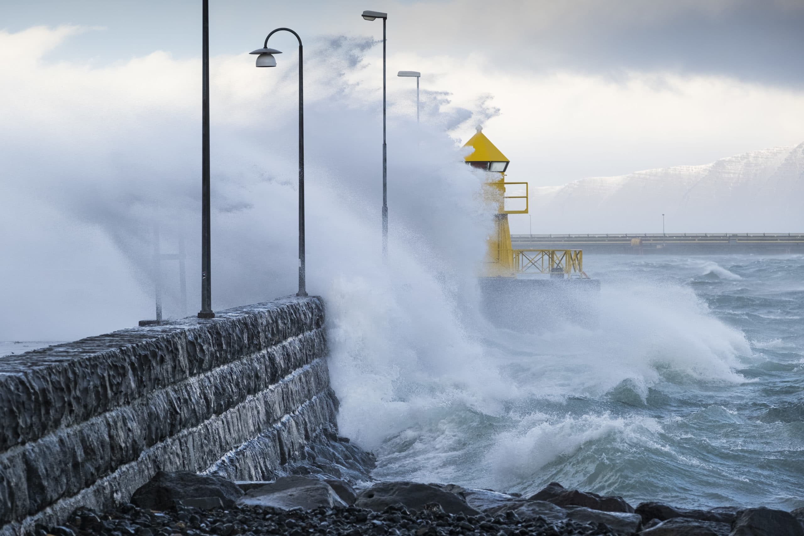 Waves crashing over Reykjavík lighthouse