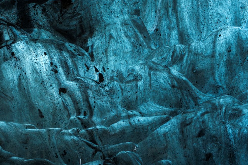 the ash-streaked ice walls of the Sapphire Ice Cave.