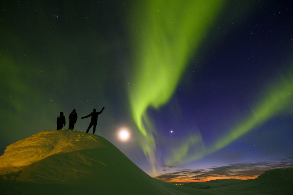 People observing the Northern Lights in Iceland